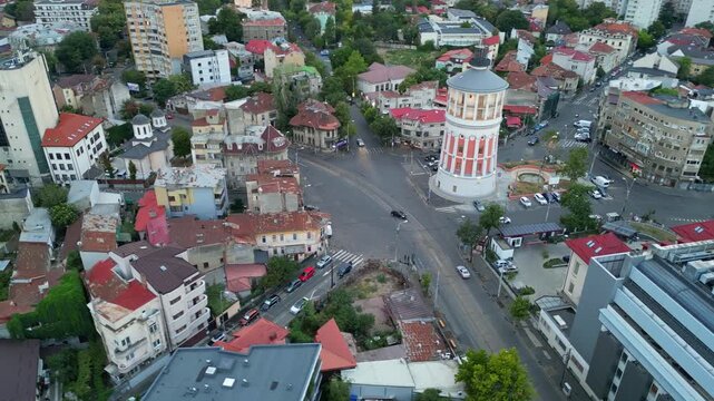 High angle daytime view of the historic Bucharest fire tower in Romania. Beautiful old circular brick architecture surrounded by urban city streets.