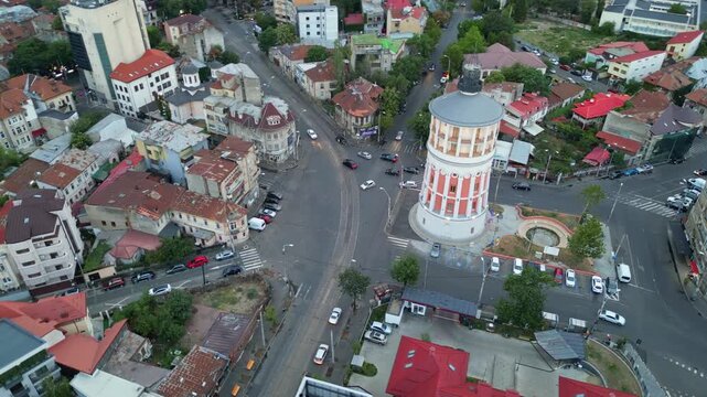 High angle daytime view of the historic Bucharest fire tower in Romania. Beautiful old circular brick architecture surrounded by urban city streets.