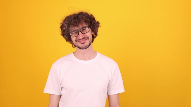 Person smiling warmly in a bright yellow studio portrait, creating a positive friendly mood with a clean minimal look.