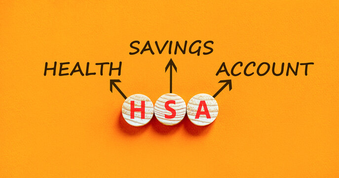 HSA health saving account symbol. Concept words HSA health saving account on beautiful wooden circles. Beautiful orange background. Medical HSA health saving account concept. Copy space.