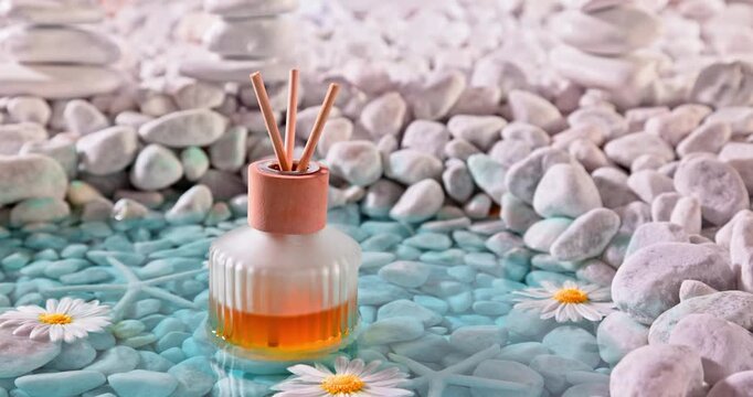Aromatic diffuser fragrance on the shore of sea ??white stones.