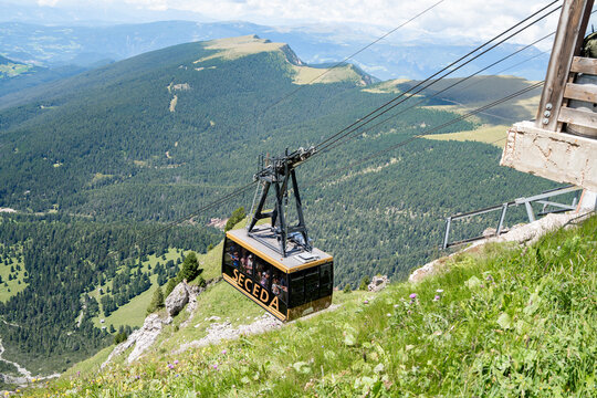 Ortisei, Italy - 22 July 2025: Cable car to Seceda mountain in Val Gardena filled with tourists on a sunny summer day