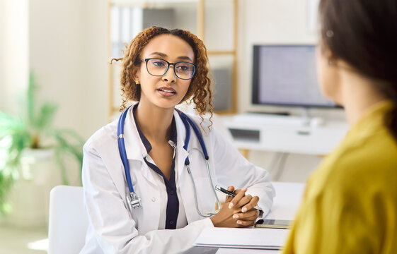 Doctor patient consultation in clinic healthcare appointment. Physician explains results and next steps, offering guidance with stethoscope in a modern office. Clear concept of patient care.
