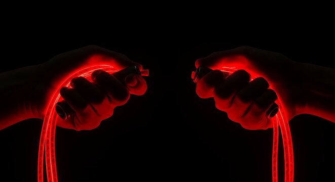 M&atilde;os segurando linhas vermelhas brilhantes contra um fundo preto: conceito art&iacute;stico abstrato
