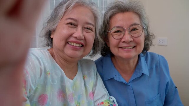 Warm Memories: Two elder women with gray hair and radiant smiles, in a moment of tender embrace and shared stories. An image that tells of cherished relationships, wisdom.