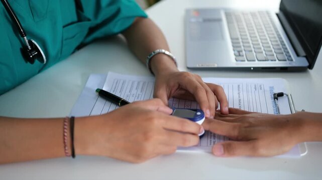 A healthcare professional is using a fingertip pulse oximeter on a patient&rsquo;s finger in a hospital room. This procedure is crucial for assessing respiratory health and blood oxygen level. Close up 
