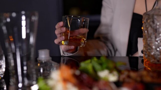 Closeup business woman holding a glass of whiskey