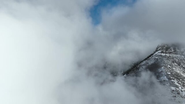 Aerial shot of the clouds and the rugged terrain of the Wasatch Mountains near Salt Lake City, Utah.