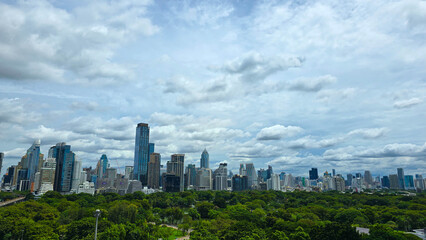 Obraz premium Bangkok city skyline view above Lumphini Park, modern skyscrapers with lush green trees