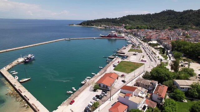 Aerial drone flying over coastal town harbor