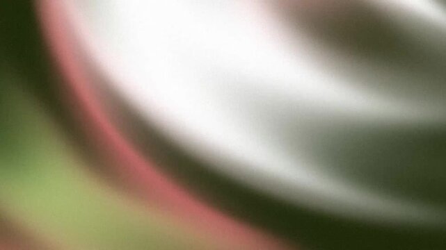 Abstract cinematic grain shifting across dark green and dusty rose canvas with nostalgic analog film texture vibes