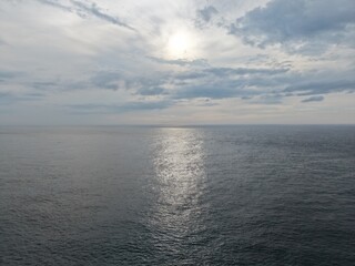 Fototapeta premium Sunlight reflecting on the surface of a vast ocean.