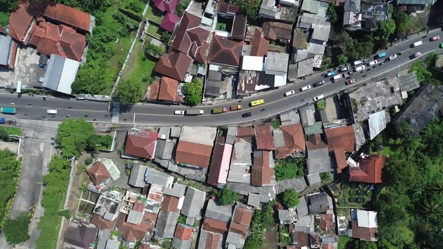 Aerial Top Down View of Curved Road and Traffic in Dense Residential Neighborhood
