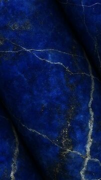 Luxury Lapis Lazuli columns rotating smoothly to reveal deep blue tones with shimmering golden pyrite inclusions and natural mineral veins throughout the surface