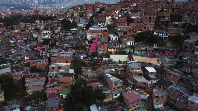 The infamous Comuna 13 hillside neighborhood in Medellin, Colombia, Evening Zoom out Aerial View of Skyline