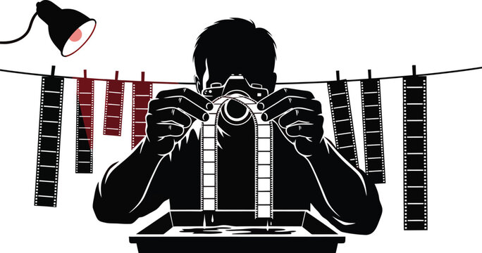 Photographer holding vintage film camera with film strips