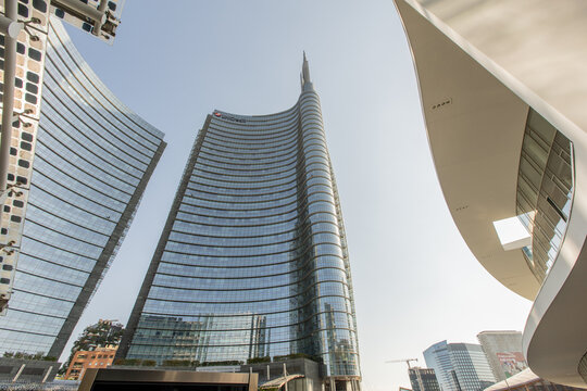 A perspective looking up at the UniCredit Tower from Piazza Gae Aulenti, highlighting the modern architectural transformation of Milan's business heart.