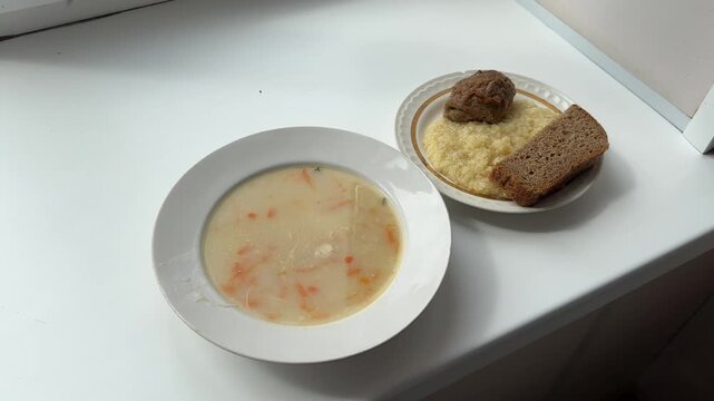 Lunch consisting of soup, porridge with cutlet and bread. Food at the hospital or maternity hospital