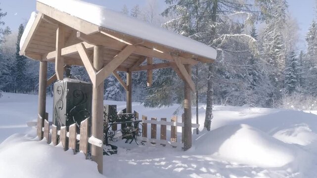 Drone passing wooden barbecue gazebo