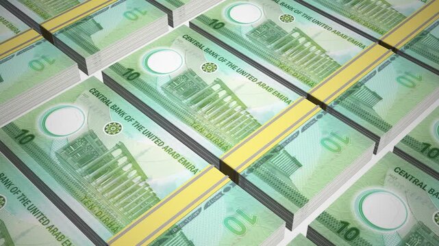 Stacks of new 10 AED or Ten United Arab Emirates Dirham Polymer banknotes or currency. Neat Rows of UAE 10 Dirham Bank note in 3D Motion. 4k Animation.