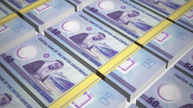 Stacks of new 50 AED or Fifty United Arab Emirates Dirham Polymer banknotes or currency. Neat Rows of UAE 50 Dirham Bank note in 3D Motion. 4k Animation.