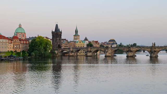 Charles Bridge on Vltava river in city of Prague in Czechia (Czech Republic), late afternoon.