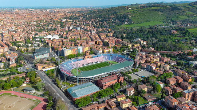 4K aerial drone view of Stadio Renato Dall'Ara, Bologna FC, historic stadium surrounded by terracotta cityscape, Bologna, Italy