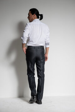 Studio portrait of an Asian man wearing a white shirt.