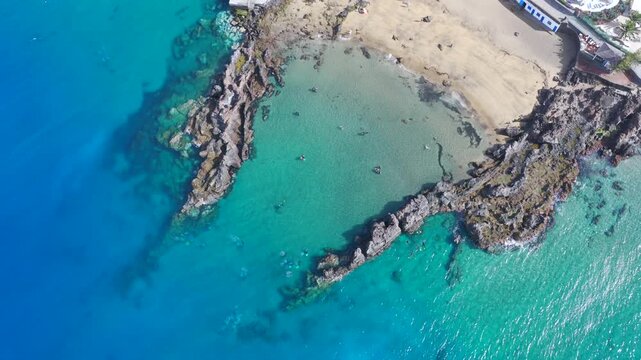Aerial Drone View of Scuba Divers Training in Crystal Clear Coastal Waters of Puerto del Carmen Lanzarote