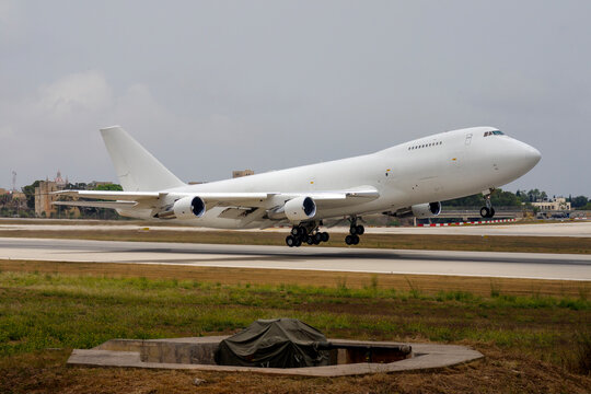 Luqa, Malta - June 15, 2005: All white Dubai Air Wing Boeing 747-2B4BM(SF) (REG: A6-GDP) taking off from runway 14.