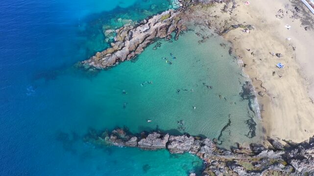 Aerial Drone View of Scuba Divers Training in Crystal Clear Coastal Waters of Puerto del Carmen Lanzarote
