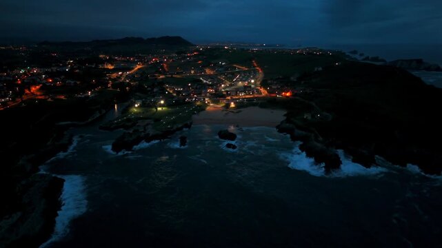 Drone view of a glowing seaside town surrounding a sheltered bay in Santander Spain