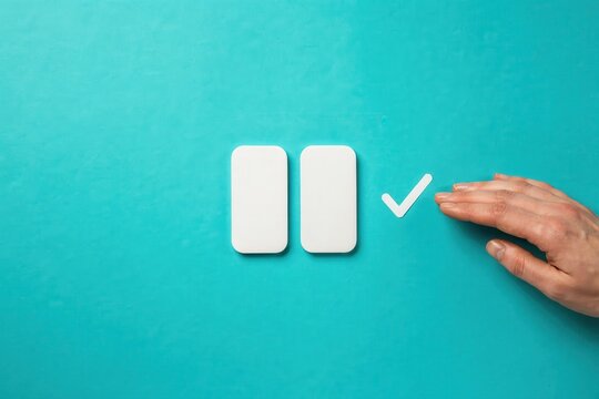 A hand interacts with pause and play buttons on a teal background