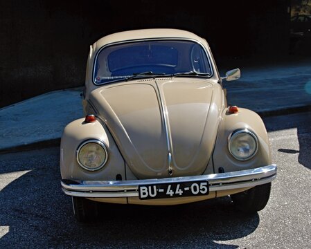 Beige Volkswagen Beetle parked in the sun