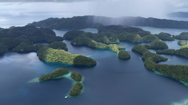 Low rain clouds drift over Palau's scenic Rock Islands. This tiny and beautiful island-nation is a popular destination for divers, snorkelers, kayakers, and World War II buffs. 