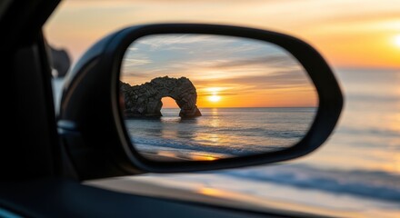 Fototapeta premium Silhouette of a bridge at sunset reflected in car side mirror