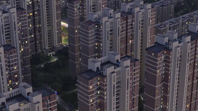 Aerial photography of urban residential areas with numerous high-rise buildings at sunset.