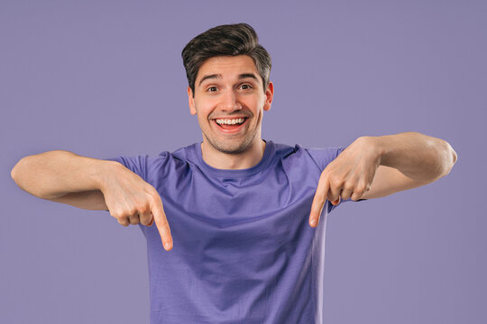 Mature Man Points Both Index Fingers Downward To Indicate Area Below On Violet