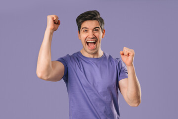 Fototapeta premium Handsome Surprised Man With Triumph Yes Victory Gesture. Jackpot, Win, Success.