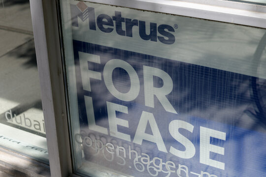 Metrus Properties For Lease sign inside window of 230 Adelaide St E (corner of Adelaide St E and Jarvis St), a prime commercial/retail offering, St Lawrence Market area, Toronto
