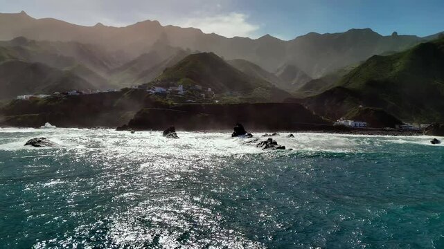 Drone approach to Almaciga village from ocean, Roque de las Bodegas, Tenerife