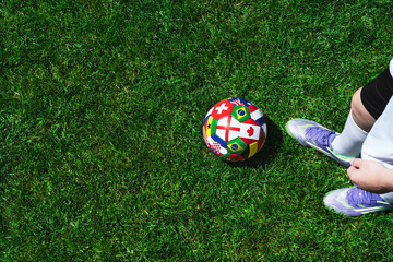 Naklejka premium Feet of soccer player step on soccer ball for kick off in stadium
