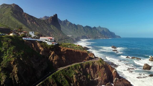 Drone flight over Roque de las Bodegas coastal road and Atlantic waves, Tenerife