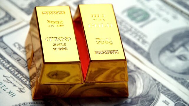 Glimmering gold bars are artfully arranged atop fresh hundred dollar bills, creating a stunning display of wealth that dazzles the eye