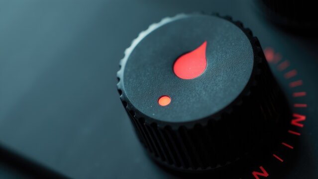 Close-up of a knob with a red light, often used in industrial or technical settings