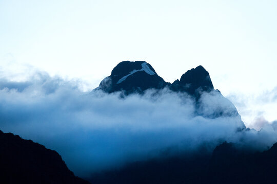 Snowy mountain summit rising above cloud layer Andes, Peru - April 30, 2019 LHO Rami