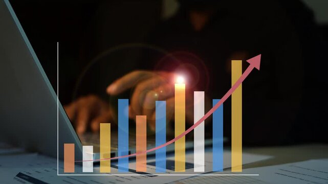 Hand touching hologram business graph bar with laptop,  Business bar chart and rising arrow overlay on a laptop desk showing business growth financial success data analysis