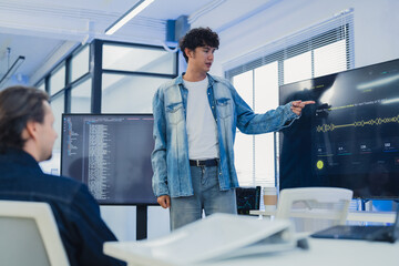 Fototapeta premium Businessman presenting voice AI software on screen to diverse team for sales report marketing campaign tech startup creative collaboration strategy hybrid workspace office background