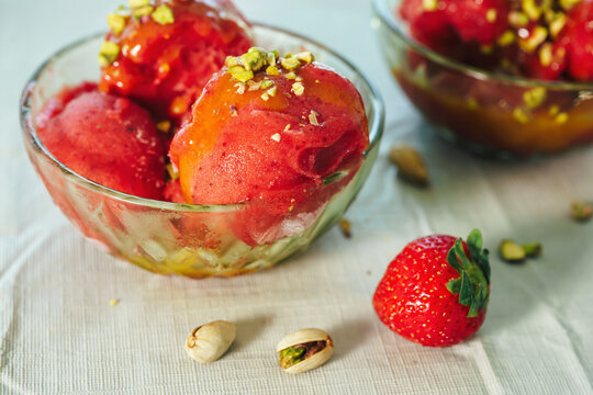 Homemade strawberry sorbet served in a glass bowl. Fresh fruit dessert and summer refreshment concept