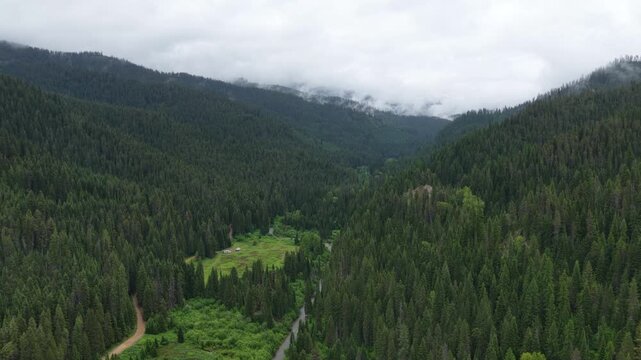 Aerial of RVs camped in Saint Joe National Forest along Idaho Montana border with stormy spring skies